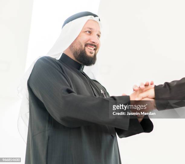 arabic adult man to handshake - agal stock pictures, royalty-free photos & images