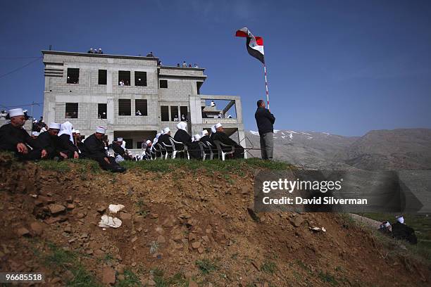 Druze man waves a Syrian flag as his community rallies close to the Syrian border in support the Damascus regime on February 14, 2010 in Majdal Shams...