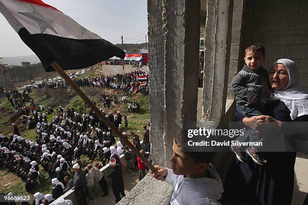 Druze youth waves a Syrian flag as the local Druze communities rallies in support the Damascus regime on February 14, 2010 in Majdal Shams in the...