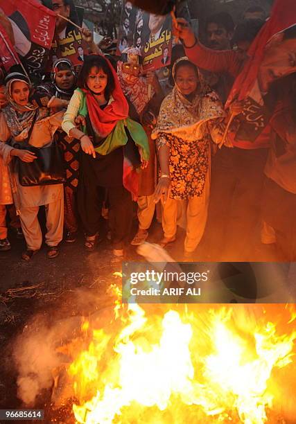 Supporters of Pakistan�s President Asif Ali Zardari set alight an effigy of opposition leader Nawaz Sharif during a protest rally in Lahore on...