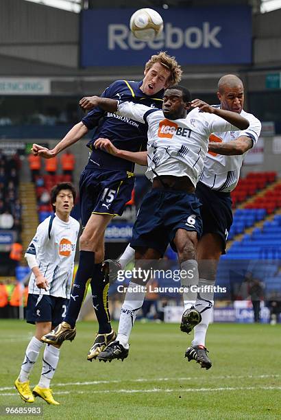 Peter Crouch of Tottenham Hotspur goes up for a header with Zat Knight and Fabrice Muamba of Bolton Wanderers during the FA Cup sponsored by E.ON...