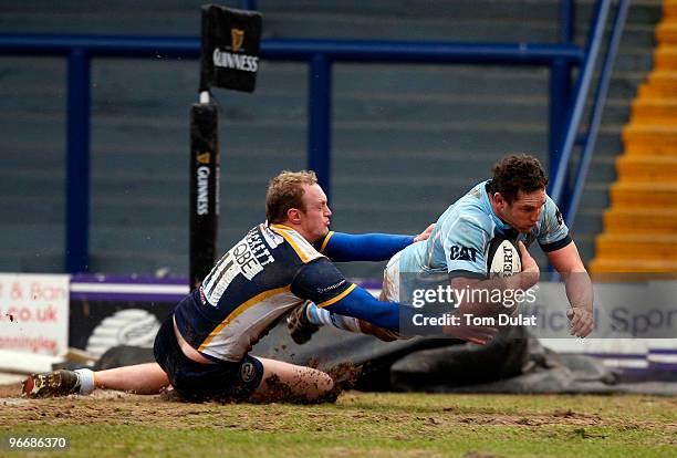 Lee Blackett of Leeds Carnegie fails to stop Craig Newby of Leicester Tigers from scoring a try during the Guinness Premiership match between Leeds...