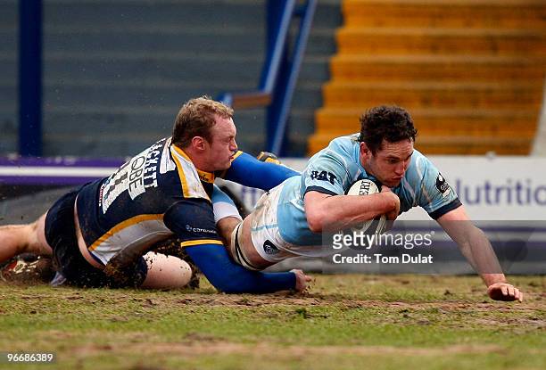 Lee Blackett of Leeds Carnegie fails to stop Craig Newby of Leicester Tigers from scoring a try during the Guinness Premiership match between Leeds...