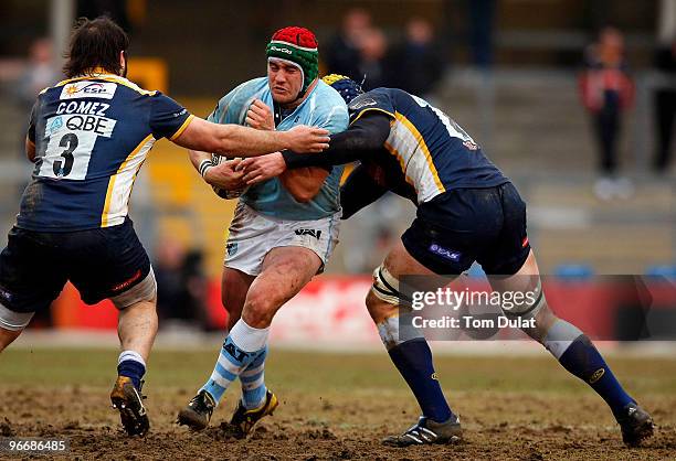 Marcos Ayerza of Leicester Tigers is tackled by Juan Gomez and Erik Lund of Leeds Carnegie during the Guinness Premiership match between Leeds...