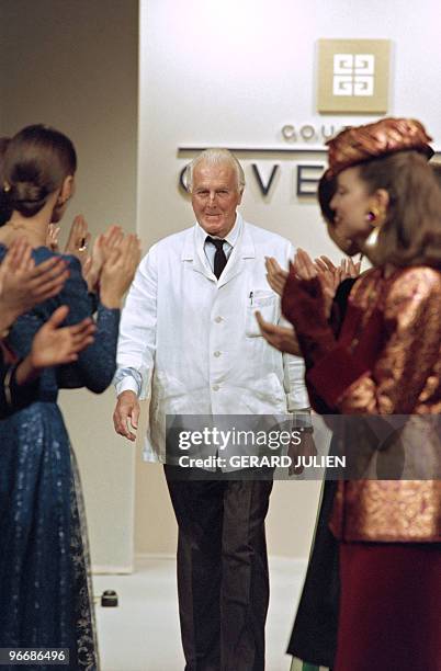 French fashion designer Hubert de Givenchy acknowledges applause at the end of his Fall/Winter 1995 ready-to-wear collection presentation in Paris on...