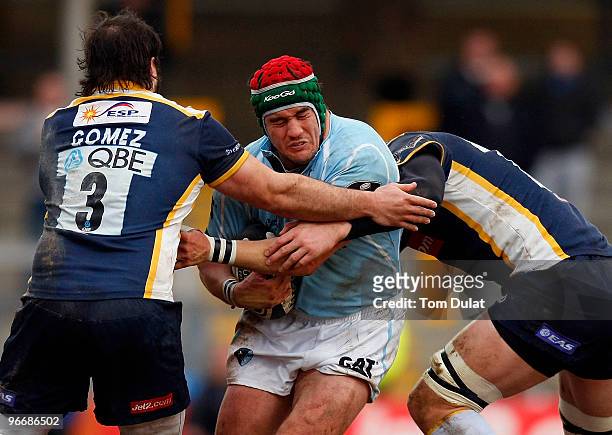 Marcos Ayerza of Leicester Tigers is tackled by Juan Gomez and Erik Lund of Leeds Carnegie during the Guinness Premiership match between Leeds...