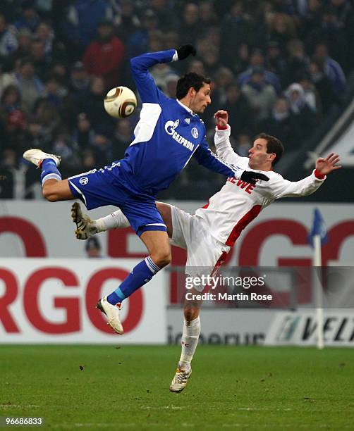 Kevin Kuranyi of Schalke and Petit of Koeln battle for the ball during the Bundesliga match between FC Schalke 04 and 1. FC Koeln at the Veltins...