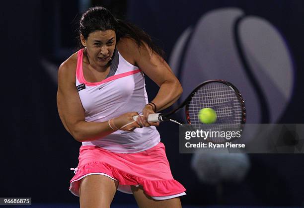 Marion Bartoli of France hits a backhand during her first round match against Ekaterina Makarova of Russia during day one of the WTA Barclays Dubai...