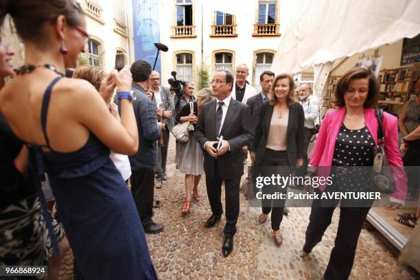 French President Francois Hollande with his partner Valerie Trierweiler walking in street on July 15, 2012 in Avignon, southern France, during a...