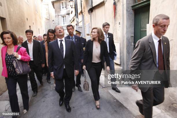 French President Francois Hollande with his partner Valerie Trierweiler walking in street on July 15, 2012 in Avignon, southern France, during a...