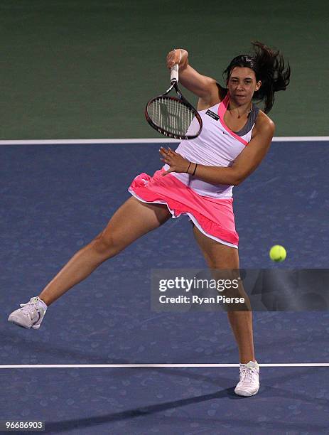 Marion Bartoli of France hits a smash during her first round match against Ekaterina Makarova of Russia during day one of the WTA Barclays Dubai...