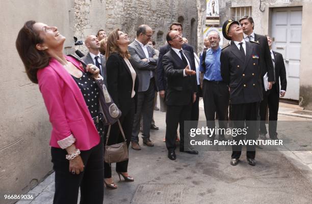 French President Francois Hollande with his partner Valerie Trierweiler walking in street on July 15, 2012 in Avignon, southern France, during a...