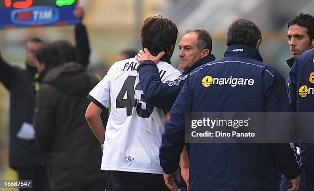 Alberto Paloschi of Parma is helped from the pitch after sustaining an injury to the head coach Francesco Guidolin during the Serie A match between...