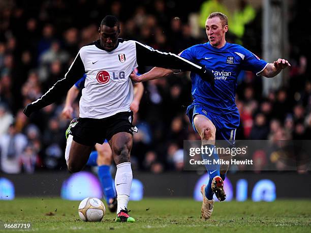 Stefano Okaka of Fulham beats Ben Davies of Notts County then shoots and scores the fourth goal of the game during the FA Cup sponsored by E.ON fifth...