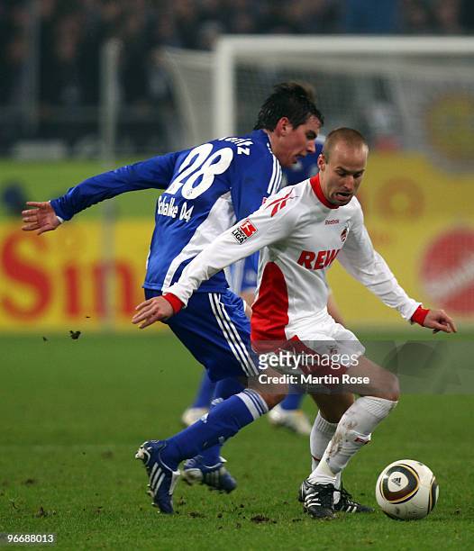 Christoph Moritz of Schalke and Miso Brecko of Koeln battle for the ball during the Bundesliga match between FC Schalke 04 and 1. FC Koeln at the...