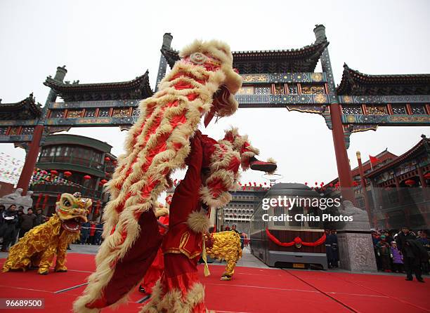 Performers play Lion Dance at the Qianmen Avenue during Spring Festival celebrations on February 14, 2010 in Beijing, China. Chinese people are...