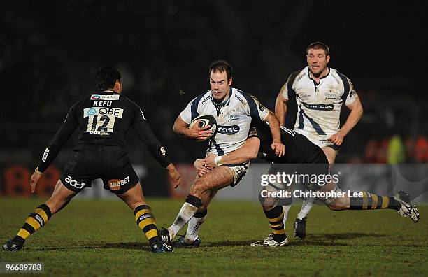 Charlie Hodgson of Sale is tackled by Will Matthews and Steve Kefu of Wasps during the Guinness Premiership match between London Wasps and Sale...