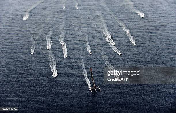 Swiss defender Alinghi huge catamaran sails during the second race of the 33rd America's Cup on February 14, 2010 off Valencia's coast. US side...