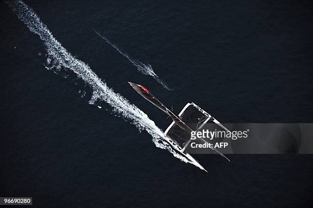 Swiss defender Alinghi huge catamaran sails during the second race of the 33rd America's Cup on February 14, 2010 off Valencia's coast. US side...
