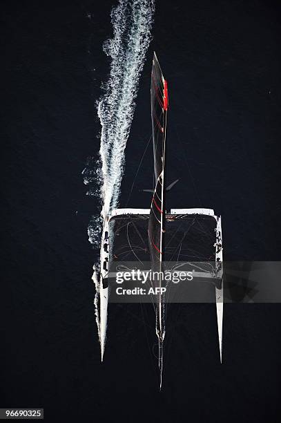 Swiss defender Alinghi huge catamaran sails during the second race of the 33rd America's Cup on February 14, 2010 off Valencia's coast. US side...