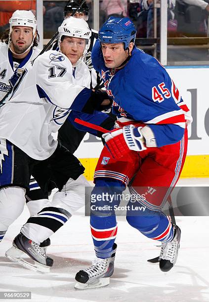 Jody Shelley of the New York Rangers skates for the puck in the first period against Todd Fedoruk of the Tampa Bay Lightning on February 14, 2010 at...