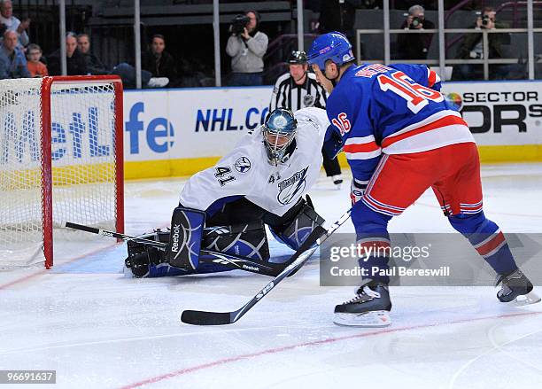 Sean Avery of the New York Rangers fakes goalie Mike Smith of the Tampa Bay Lightning out of the goal to score a goal on a penalty shot during the...