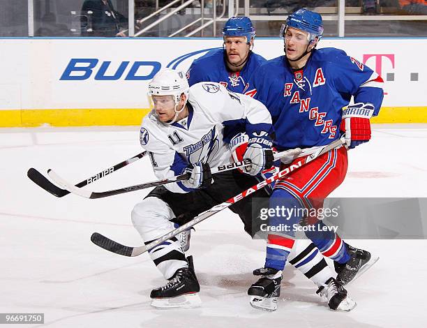 Jeff Helpern of the Tampa Bay Lightning skates for the puck under pressure by Olli Jokinen and Ryan Callahan of the New York Rangers in the second...