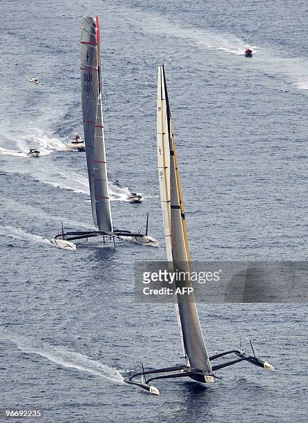 Challenger Oracle giant trimaran and Swiss defender Alinghi huge catamaran sail during the second race of the 33rd America's Cup on February 14, 2010...