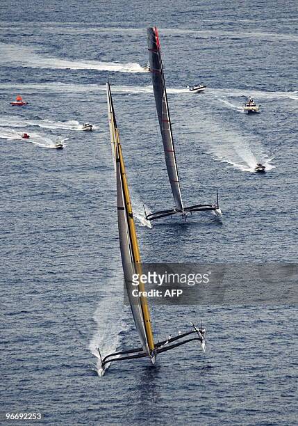 Challenger Oracle giant trimaran and Swiss defender Alinghi huge catamaran sail during the second race of the 33rd America's Cup on February 14, 2010...
