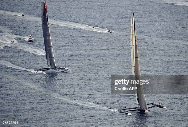 Challenger Oracle giant trimaran and Swiss defender Alinghi huge catamaran sail during the second race of the 33rd America's Cup on February 14, 2010...