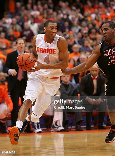 Wesley Johnson of the Syracuse Orange drives past Somardo Samuels of the Louisville Cardinals during the game at the Carrier Dome on February 14,...