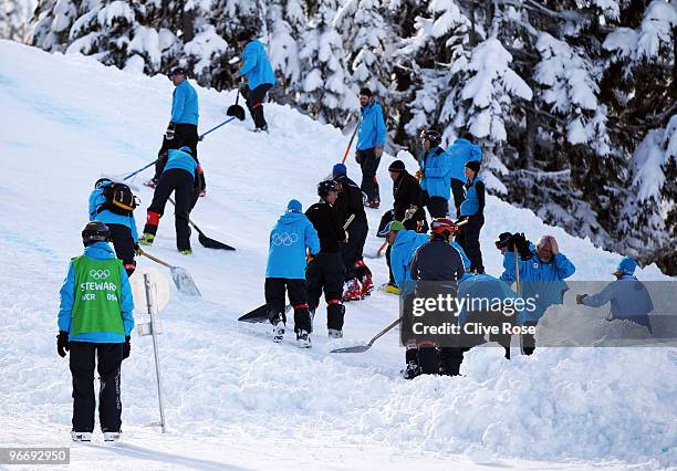 Volunteers clearing the snow during the cancelled alpine skiing women's downhill training at Whistler Creek during the Vancouver 2010 Winter Olympics...