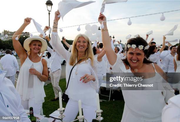 People dressed in white gather for the 30th edition of the "Diner En Blanc" event on the Invalides esplanade on June 3, 2018 in Paris, France. The...