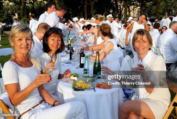 People dressed in white gather for the 30th edition of the "Diner En Blanc" event on the Invalides esplanade on June 3, 2018 in Paris, France. The...