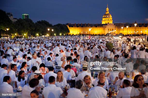 People dressed in white gather for the 30th edition of the "Diner En Blanc" event on the Invalides esplanade on June 3, 2018 in Paris, France. The...