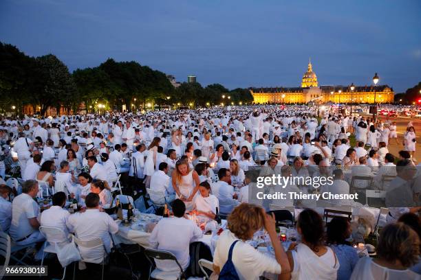 People dressed in white gather for the 30th edition of the "Diner En Blanc" event on the Invalides esplanade on June 3, 2018 in Paris, France. The...