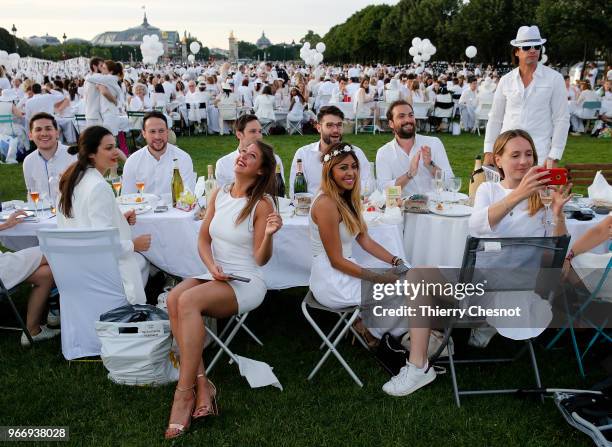 People dressed in white gather for the 30th edition of the "Diner En Blanc" event on the Invalides esplanade on June 3, 2018 in Paris, France. The...