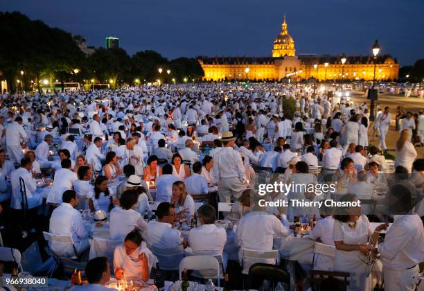 People dressed in white gather for the 30th edition of the "Diner En Blanc" event on the Invalides esplanade on June 3, 2018 in Paris, France. The...