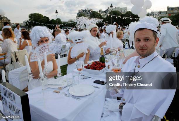 People dressed in white gather for the 30th edition of the "Diner En Blanc" event on the Invalides esplanade on June 3, 2018 in Paris, France. The...