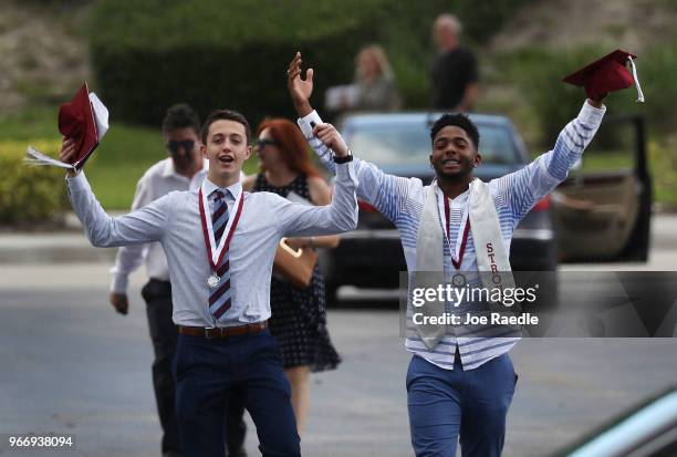 Graduates of Marjory Stoneman Douglas High School are seen as they head to their cars after attending their graduation ceremony at the BB&T Center on...