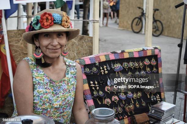 Brazilian female seen selling traditional earrings at the festival in Athens about traditional Latin-American culture with food, drinks, Latin...