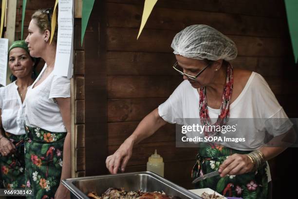 Brazilian female chef seen cooking at the festival in Athens about traditional Latin-American culture with food, drinks, Latin dances, fresh juices...