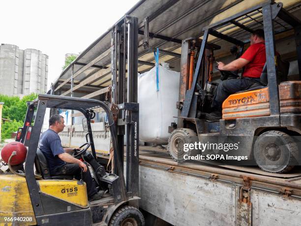 Men seen operating a forklift and loading big bags with crushed plastic bottles into the truck to be sent for further processing. In Ukraine,...