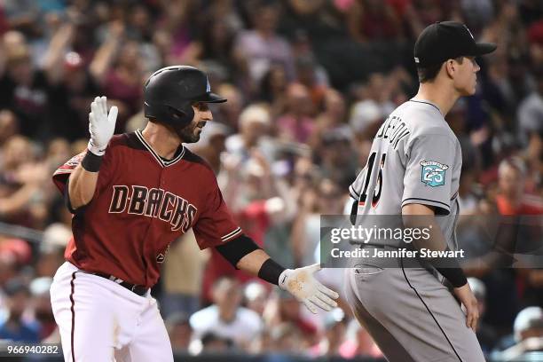 Daniel Descalso of the Arizona Diamondbacks celebrates at third base after driving in two runs in the seventh inning of the MLB game against the...