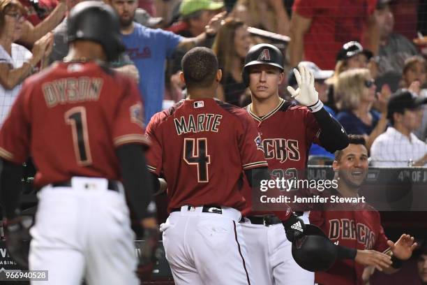 Jake Lamb of the Arizona Diamondbacks congratulates Ketel Marte and Jarrod Dyson after both scoring in the seventh inning of the MLB game against the...