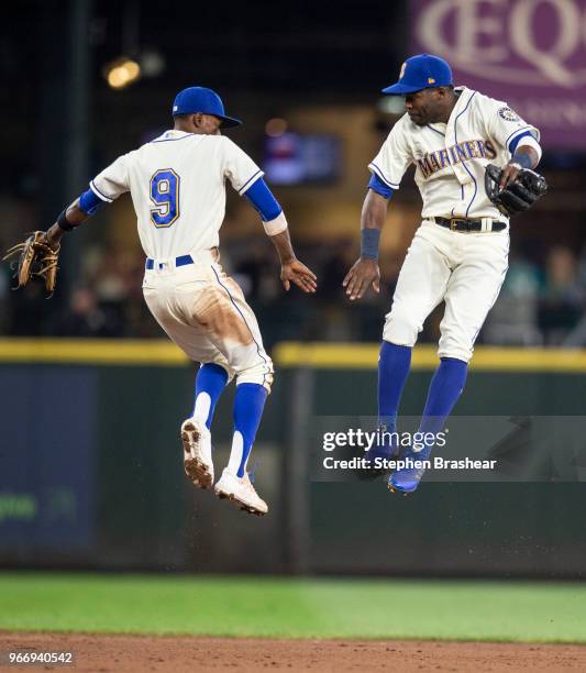 Second baseman Dee Gordon of the Seattle Mariners and Centerfielder Guillermo Heredia of the Seattle Mariners celebrate after a game against the...