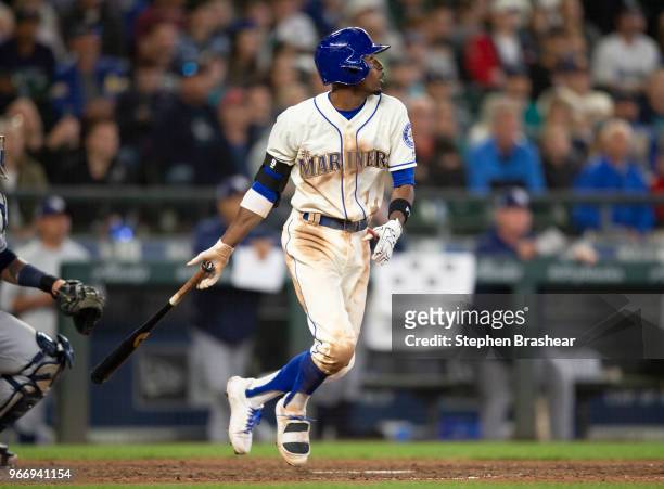 Dee Gordon of the Seattle Mariners hits a RBI-single off of relief pitcher Jose Alvarado of the Tampa Bay Rays that scored Guillermo Heredia of the...