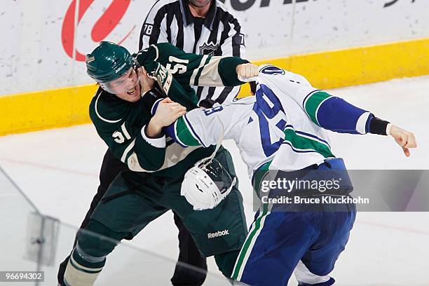 James Sheppard of the Minnesota Wild fights with Aaron Rome of the Vancouver Canucks during the game at the Xcel Energy Center on February 14, 2010...