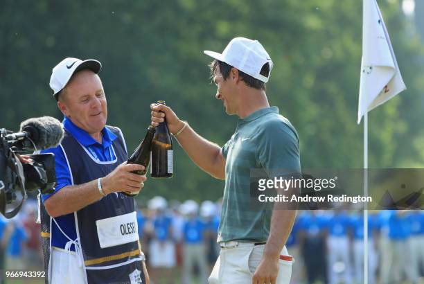 Thorbjorn Olesen of Denmark celebrates wiuth his caddie Dominic Bott on the 18th green after winning the Italian Open at Gardagolf Country Club on...