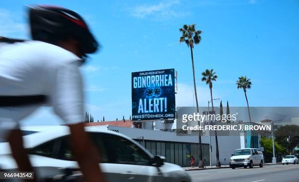 Billoard from the AIDS Healthcare Foundation is seen on Sunset Boulevard in Hollywood, California on May 29, 2018 warning of a drug resistant...